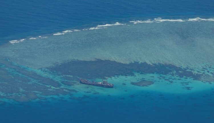 China says Philippine vessel "illegally" landed on disputed atoll